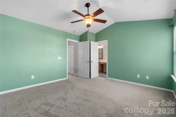 a view of an empty room with a ceiling fan and a window
