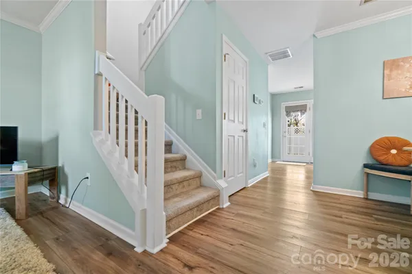 a view of entryway and hall with wooden floor