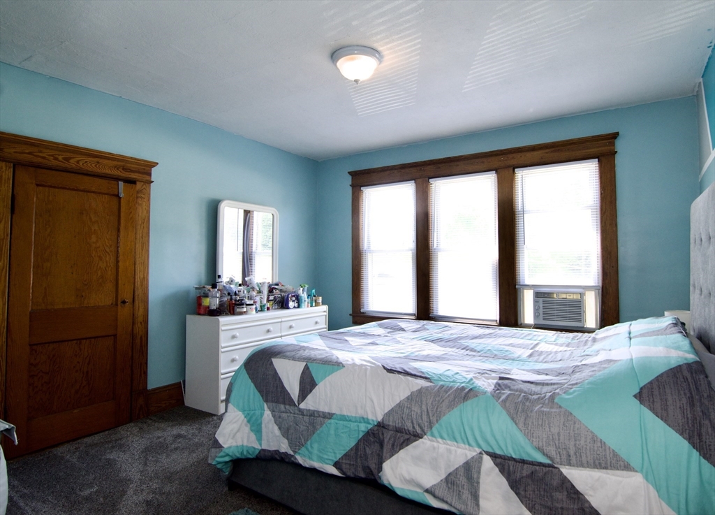 16 Amity Court Springfield, MA 01108 - Photo 26 of 42 a bedroom with a bed and large windows