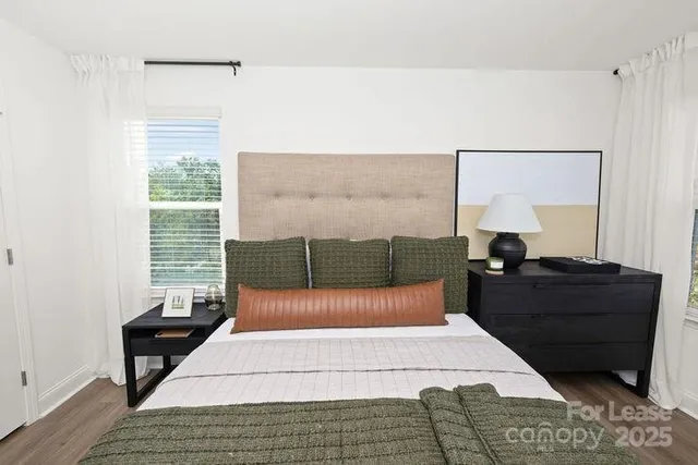 a bedroom with a large bed and a large window