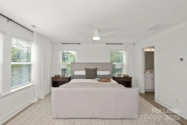 a living room with a mirror and a wooden floor