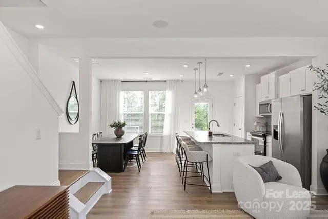 a view of a dining room with furniture window and wooden floor