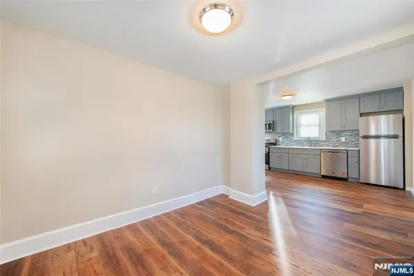 a view of a kitchen with wooden floor