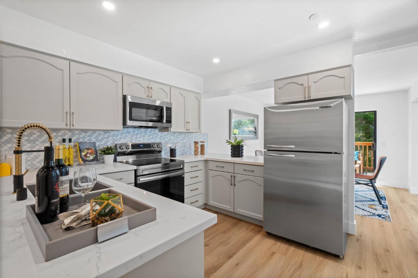 603 Sharp Park Road Pacifica, CA 94044 - Photo 11 of 27 a kitchen with white cabinets and stainless steel appliances