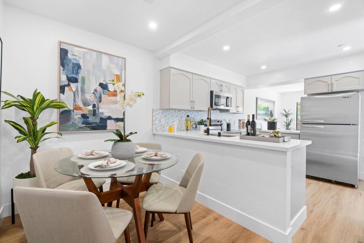 603 Sharp Park Road Pacifica, CA 94044 - Photo 12 of 27 a kitchen with stainless steel appliances a dining table chairs and wooden floor