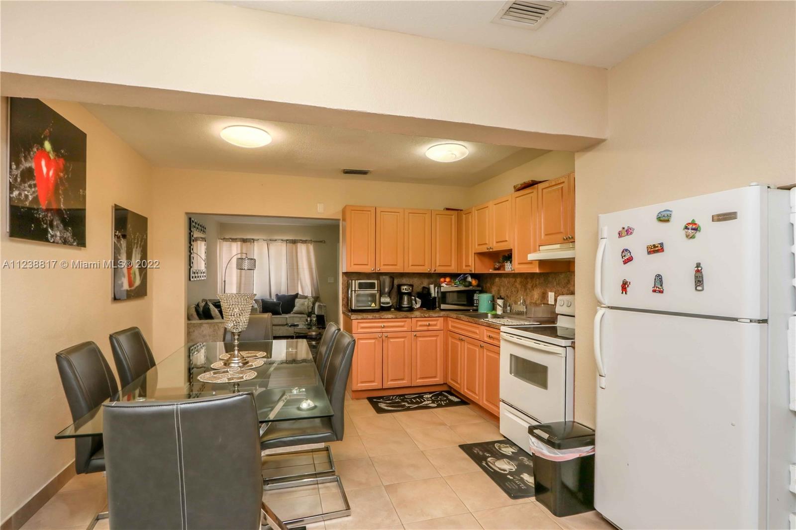 2810 Southwest 26th Street Miami, FL 33133 - Photo 11 of 33 a kitchen with stainless steel appliances granite countertop a refrigerator and a stove top oven