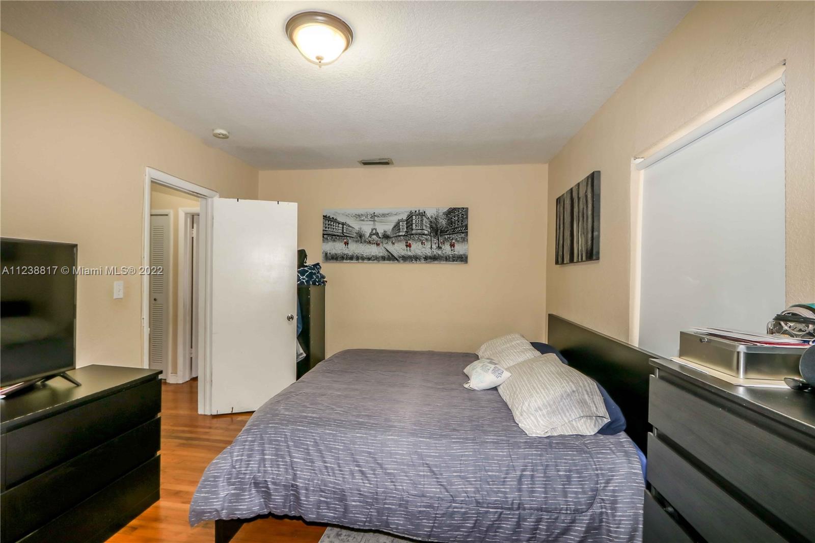 2810 Southwest 26th Street Miami, FL 33133 - Photo 13 of 33 a bedroom with a bed and a flat screen tv