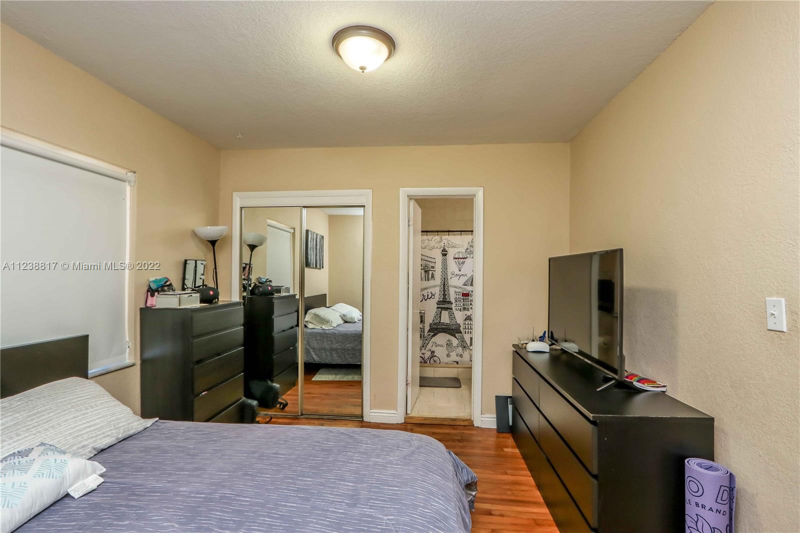 2810 Southwest 26th Street Miami, FL 33133 - Photo 14 of 33 a bedroom with a bed and a flat screen tv