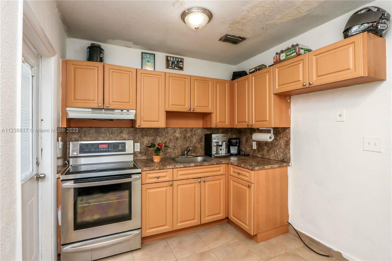 2810 Southwest 26th Street Miami, FL 33133 - Photo 27 of 33 a kitchen with white cabinets and white appliances