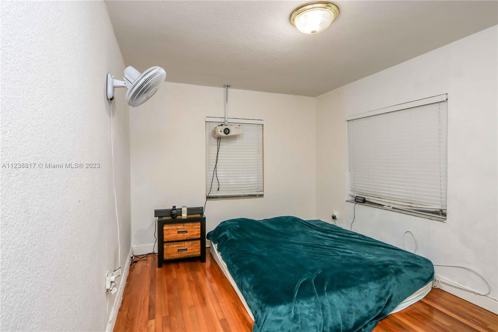 2810 Southwest 26th Street Miami, FL 33133 - Photo 29 of 33 a bedroom with a bed and a mirror