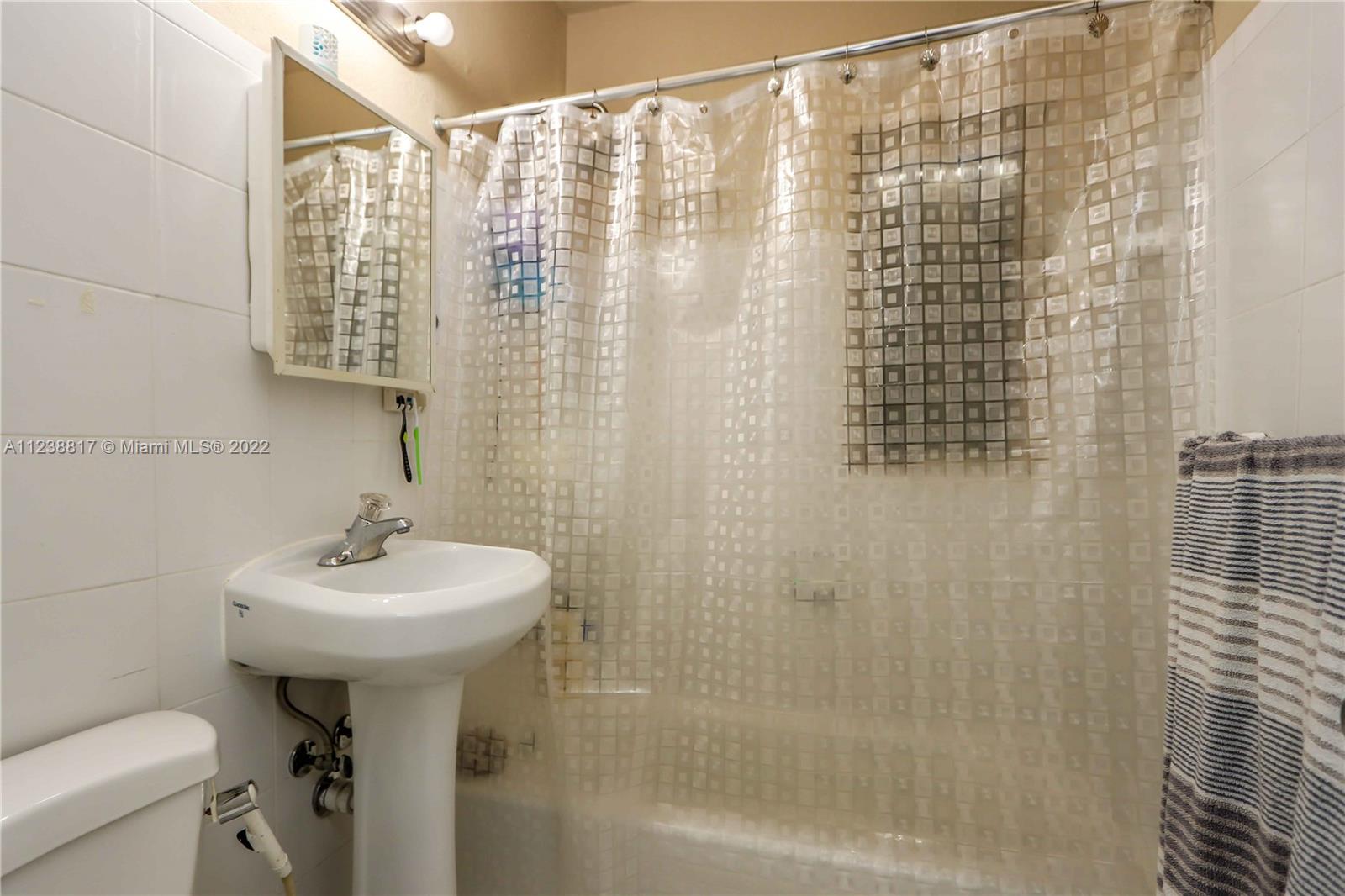 2810 Southwest 26th Street Miami, FL 33133 - Photo 33 of 33 a bathroom with a sink a toilet and shower