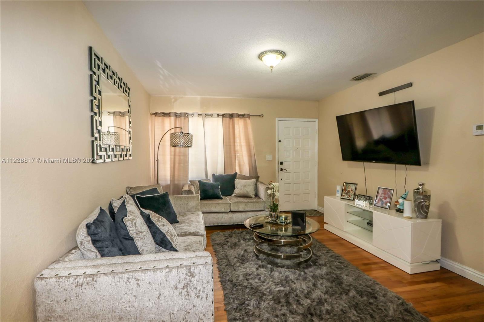 2810 Southwest 26th Street Miami, FL 33133 - Photo 8 of 33 a living room with furniture and a flat screen tv
