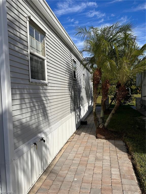 1453 Diamond Lake Circle Naples, FL 34114 - Photo 17 of 18 a view of a pathway both side of house