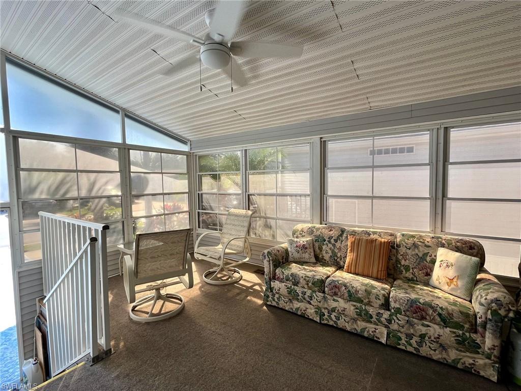 1453 Diamond Lake Circle Naples, FL 34114 - Photo 4 of 18 a living room with furniture and a floor to ceiling window