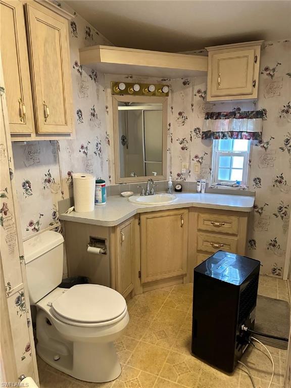 1453 Diamond Lake Circle Naples, FL 34114 - Photo 6 of 18 a bathroom with a sink a toilet and shower