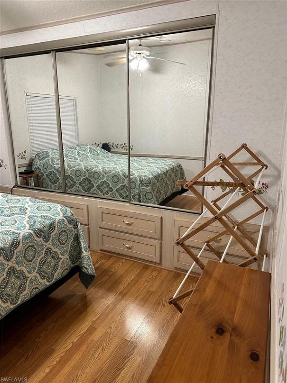 1453 Diamond Lake Circle Naples, FL 34114 - Photo 9 of 18 a bed sitting in a room next to a window