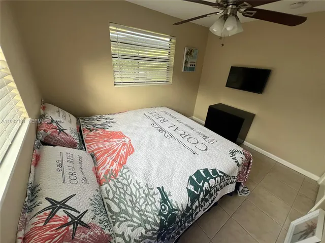 a bedroom with a bed and flat screen tv