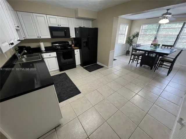 a kitchen with stainless steel appliances a refrigerator and a stove top oven
