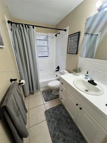 a bathroom with a double vanity sink mirror and toilet
