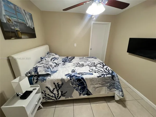 a bedroom with a bed and flat screen tv