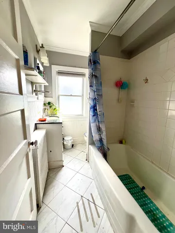 a bathroom with a toilet a sink and a window