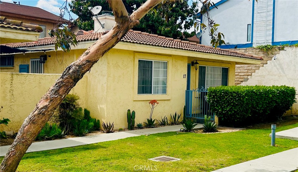 7315 Exeter Street, Unit 17 Paramount, CA 90723 - Photo 1 of 1 a front view of a house with a yard