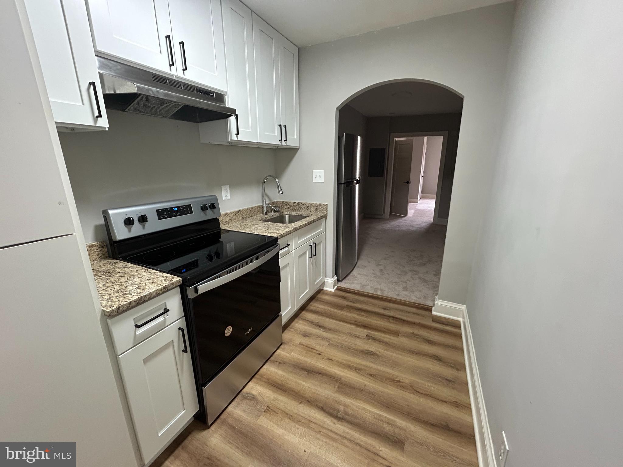 1630 16th Street Southeast, Unit 2 Washington, DC 20020 - Photo 3 of 15 a kitchen with granite countertop a stove and a sink