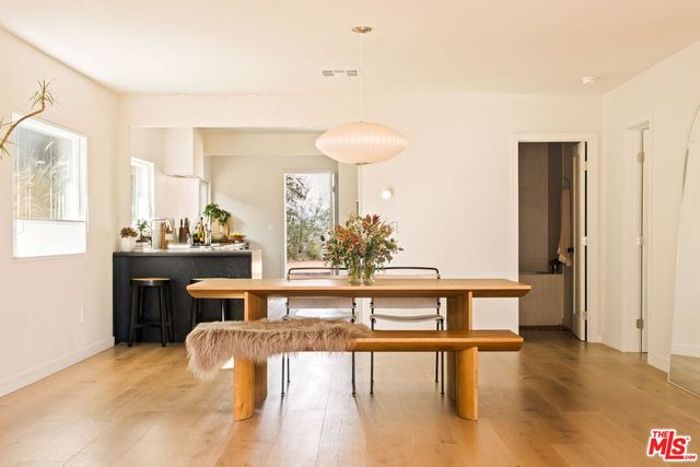 a dining room with furniture a potted plant and a chandelier