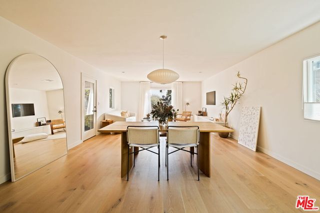 a dining hall with granite countertop a sink a stove and a dining table