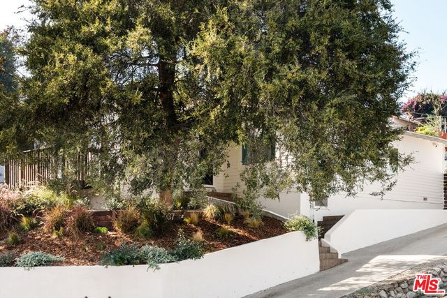 a view of a yard with wooden fence