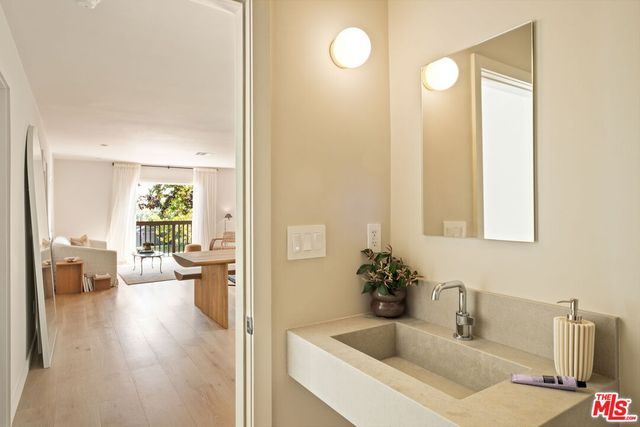 a bathroom with a sink a toilet and a mirror