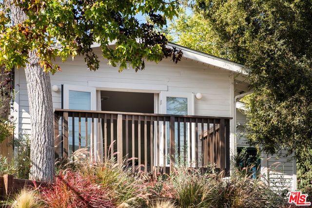 a porch with table and chairs
