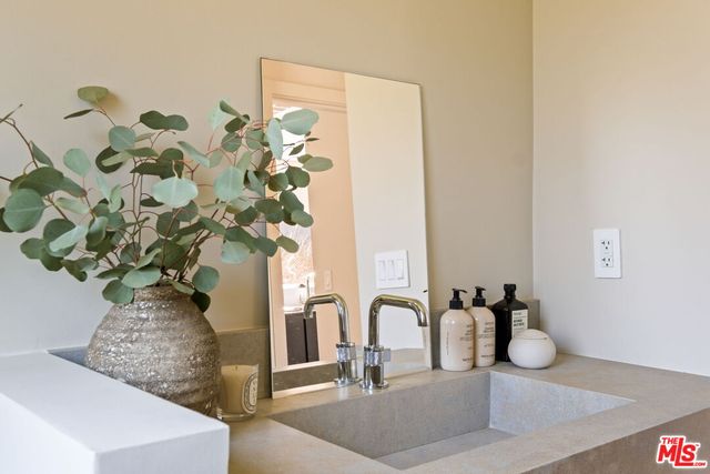 a bedroom with a bed and a chair