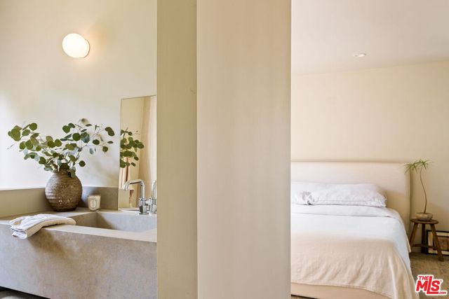 a bedroom with a bed and a window