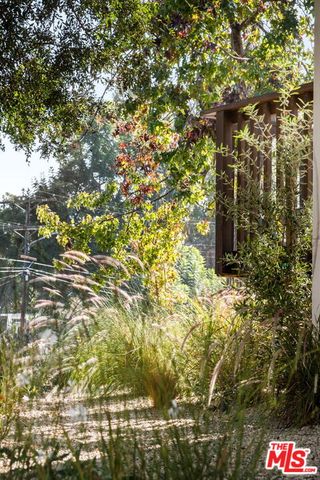 a balcony with wooden floor table and chairs