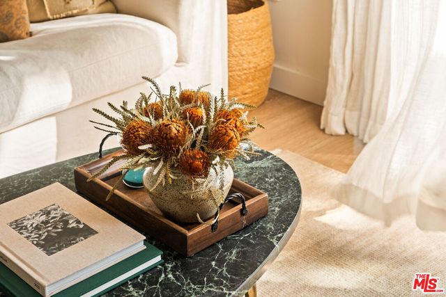 a living room with furniture a table and kitchen view