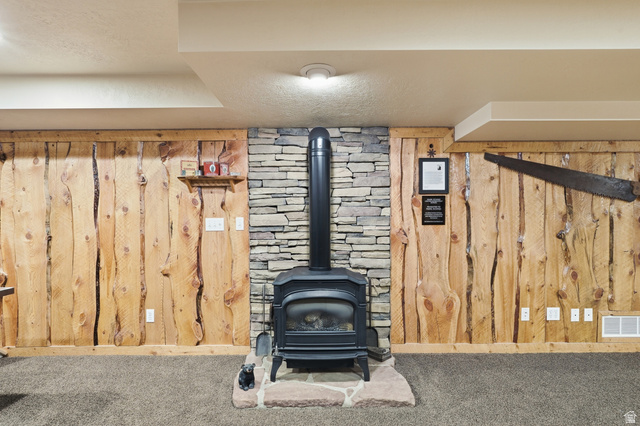 2420 West Old Hwy Road Morgan, UT 84050 - Photo 28 of 54 Detailed view of a textured ceiling, a gas stove, wooden walls, and carpet floors