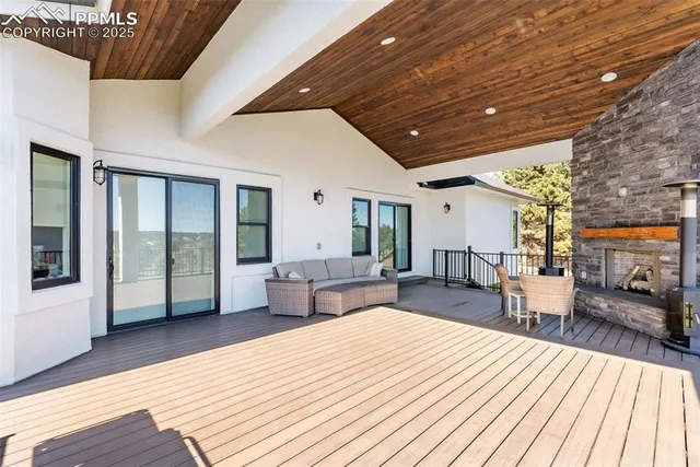 a outdoor space with wooden floor and barbeque oven