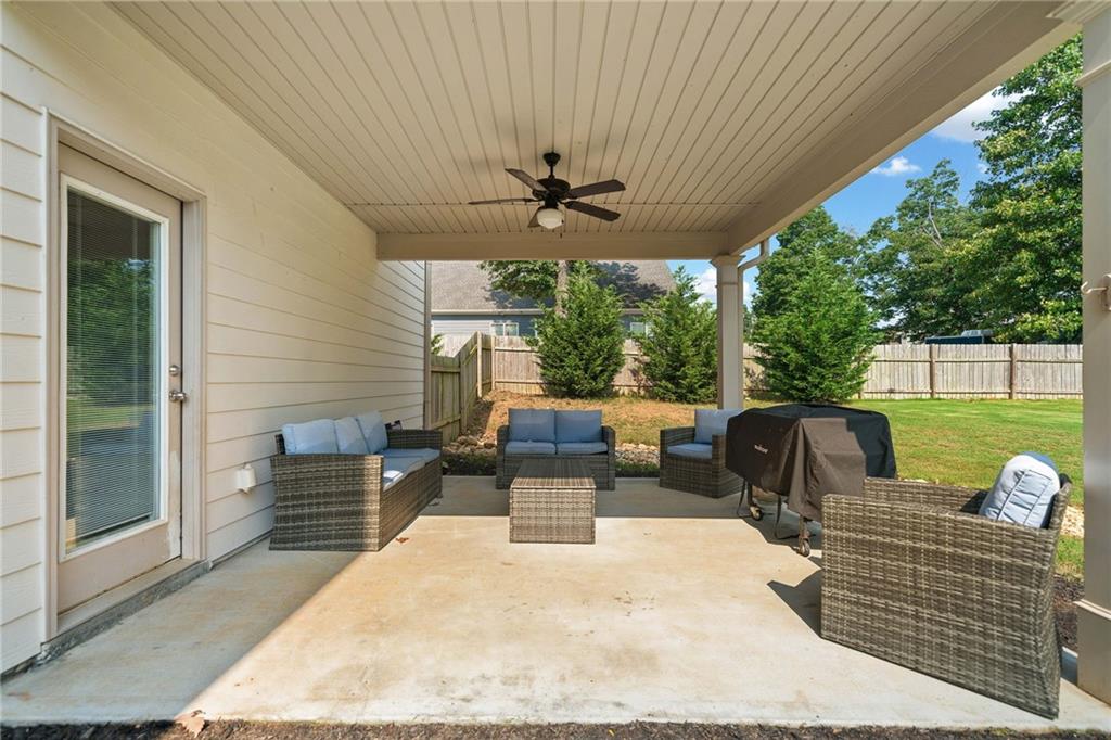 13 Four Feathers Lane Northeast Rydal, GA 30171 - Photo 42 of 51 a view of a patio with a table chairs and a backyard