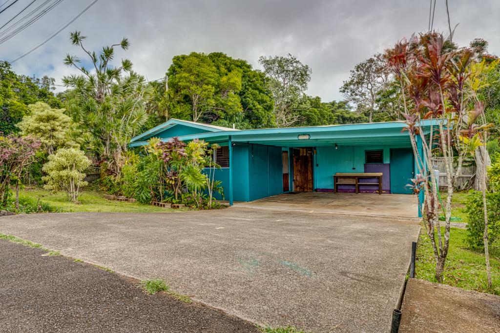 720 Mopua Street Haiku, HI 96708 - Photo 4 of 22 a front view of a house with a yard and a garage