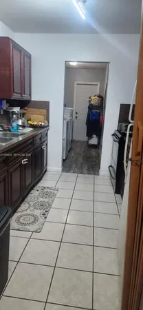 a kitchen with a sink and a stove top oven