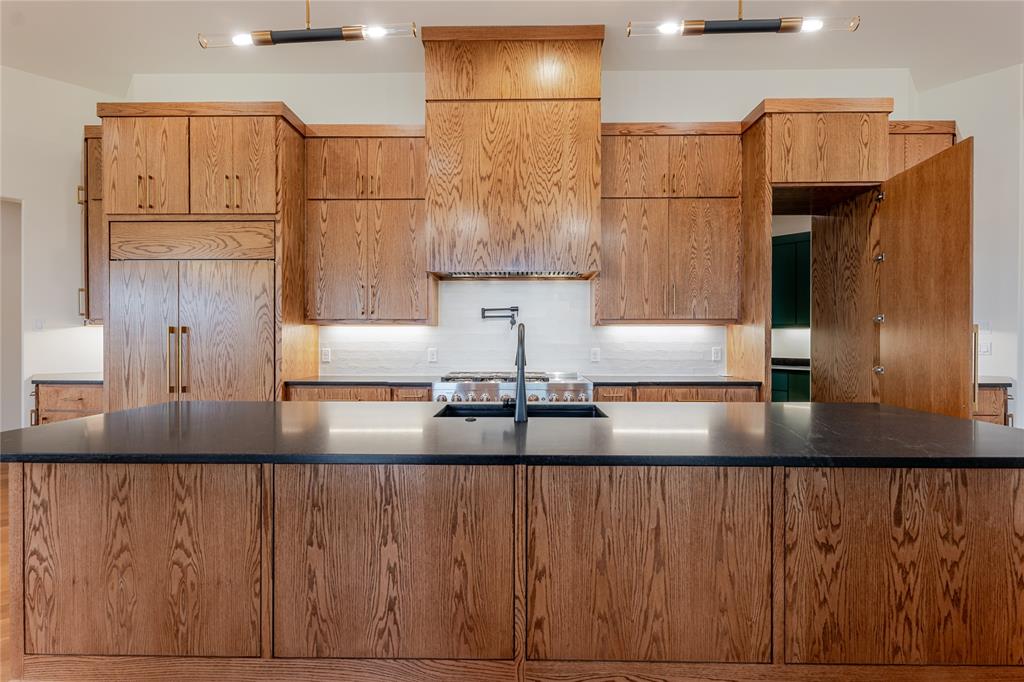 2005 Denali Pass Aledo, TX 76008 - Photo 15 of 36 a kitchen with kitchen island granite countertop a sink window and cabinets