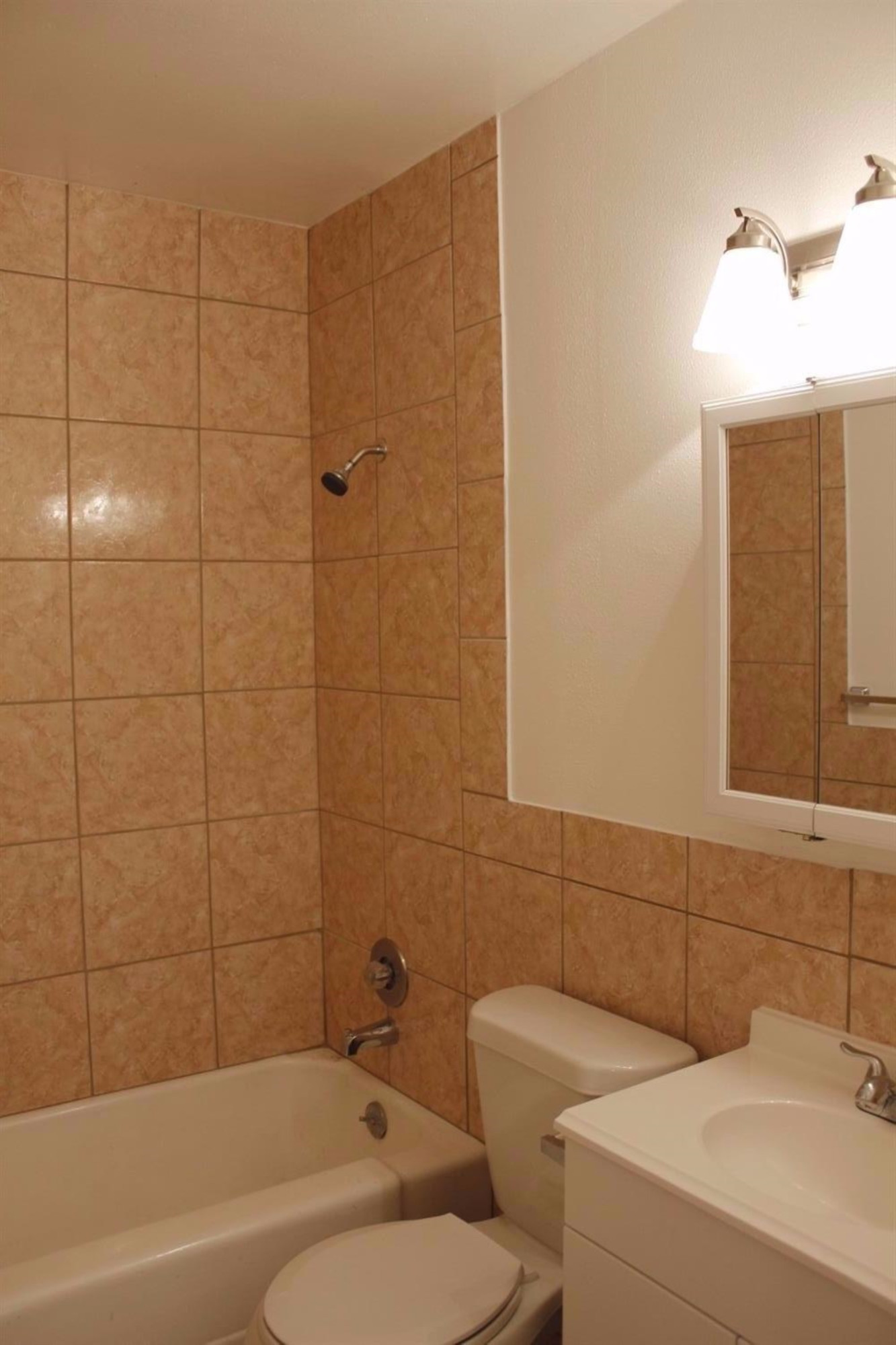 2222 22nd Street Lubbock, TX 79411 - Photo 6 of 9 a bathroom with a toilet sink and bathtub