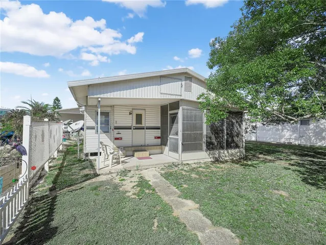 a view of a backyard with wooden fence