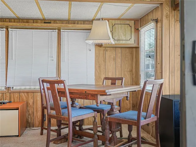 a view of a workspace with furniture and windows