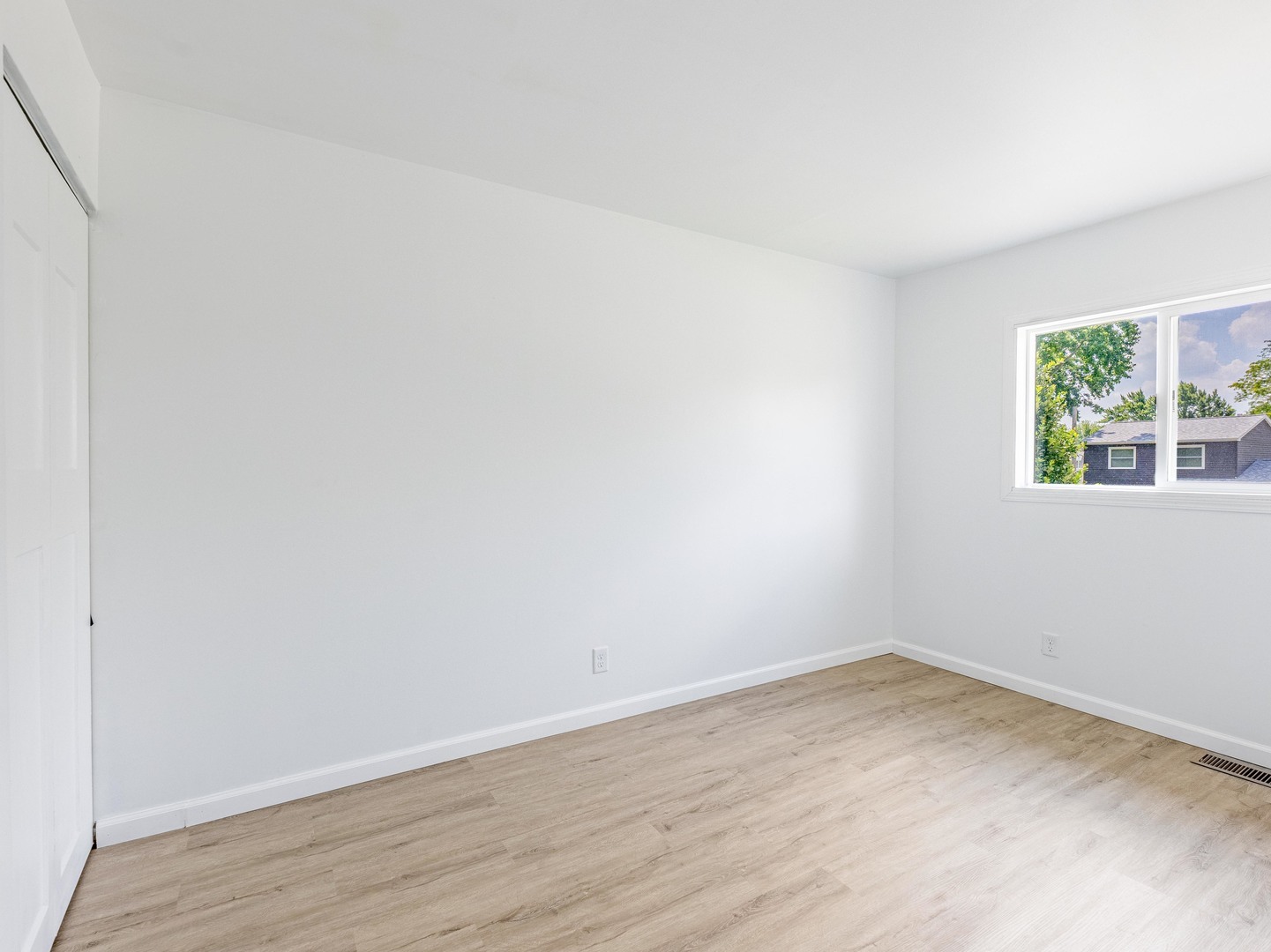 228 Riverside Drive Bolingbrook, IL 60440 - Photo 11 of 22 wooden floor in an empty room with a window