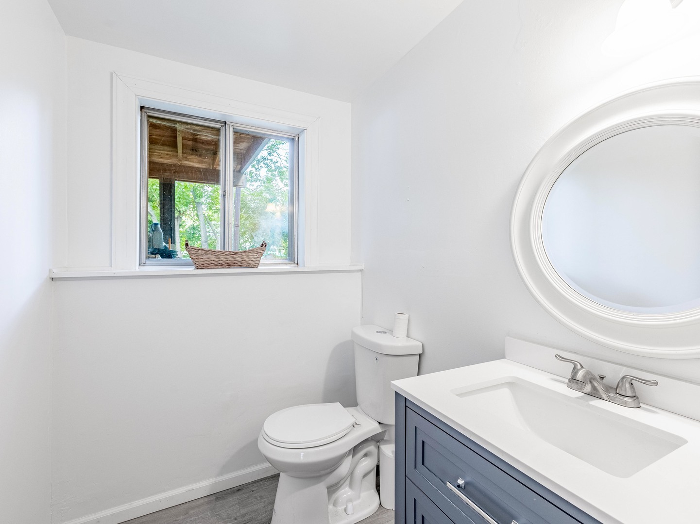 228 Riverside Drive Bolingbrook, IL 60440 - Photo 16 of 22 a bathroom with a toilet a sink a mirror and a window