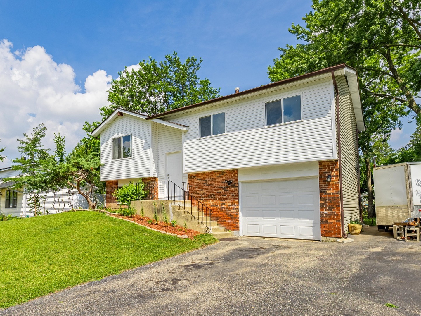 228 Riverside Drive Bolingbrook, IL 60440 - Photo 22 of 22 a front view of a house with a yard and garage
