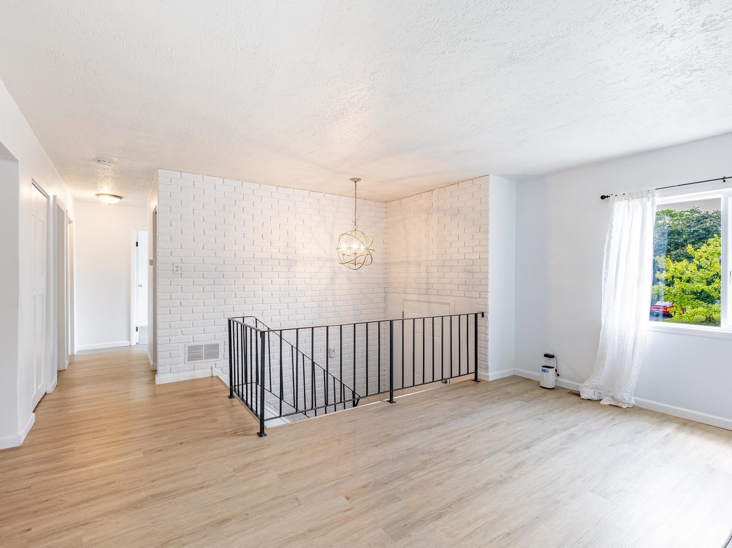 228 Riverside Drive Bolingbrook, IL 60440 - Photo 3 of 22 a view of a room with wooden floor and natural light