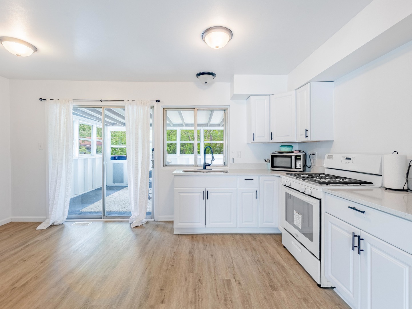 228 Riverside Drive Bolingbrook, IL 60440 - Photo 5 of 22 a kitchen with cabinets appliances and a wooden floor